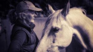 Trudi Dempsey having a quiet moment with her grey horse close to her